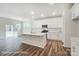 A modern kitchen boasts white cabinets, stainless appliances, an island, and an open layout at 2783 Ashton Park Ln # 67, Monroe, NC 28110