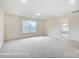 A spacious living room with plush carpeting, recessed lighting, and natural light at 2783 Ashton Park Ln # 67, Monroe, NC 28110