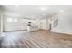 Open-concept living area featuring modern kitchen, island, and wood-look flooring at 2783 Ashton Park Ln # 67, Monroe, NC 28110