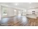 Expansive living room with modern flooring, large windows, and an open layout leading to the kitchen, perfect for entertaining at 2783 Ashton Park Ln # 67, Monroe, NC 28110