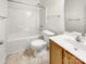Well-lit bathroom featuring a shower-tub combo and a wood vanity at 2924 Zion Renaissance Ln, Charlotte, NC 28269