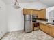 Bright, empty kitchen features stainless steel appliances and light-colored cabinetry awaiting a personal touch at 2924 Zion Renaissance Ln, Charlotte, NC 28269