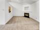Spacious living room featuring a cozy fireplace and neutral carpet, offering a blank canvas for personalization at 2924 Zion Renaissance Ln, Charlotte, NC 28269