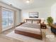 Tranquil primary bedroom with a cozy rug, natural light, and warm wood accents for a serene retreat at 2924 Zion Renaissance Ln, Charlotte, NC 28269