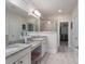 Well-lit bathroom with double vanity, granite counters, and walk-in closet access at 303 Ridge Reserve Dr # 29, Clover, SC 29710
