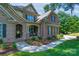 Inviting two-story home with a covered front porch, stone accents, and meticulously landscaped front yard at 303 Ridge Reserve Dr # 29, Clover, SC 29710