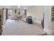 Large living room with plush carpet, neutral walls, and coffered ceiling, offering a versatile living space at 303 Ridge Reserve Dr # 29, Clover, SC 29710