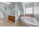 Bright bathroom with a large soaking tub, tiled surround, and double sink vanity at 3208 Fifth Baxter Xing, Fort Mill, SC 29708