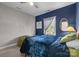 Bedroom featuring a navy accent wall, gray wall, and a plush comforter at 3208 Fifth Baxter Xing, Fort Mill, SC 29708