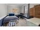 Comfortable bedroom features a cozy bed with blue accents, desk setup, and soft carpeting, creating a relaxed atmosphere at 3208 Fifth Baxter Xing, Fort Mill, SC 29708
