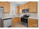 Functional kitchen space with stainless steel appliances, light wood cabinets, and a bright window at 3208 Fifth Baxter Xing, Fort Mill, SC 29708