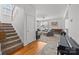 Inviting living room with natural light, plush carpet, neutral paint, and staircase access, for a cozy and welcoming atmosphere at 3208 Fifth Baxter Xing, Fort Mill, SC 29708