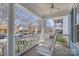 Front porch with white rocking chairs, white pillars and a ceiling fan at 3208 Fifth Baxter Xing, Fort Mill, SC 29708
