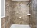 Bathroom shower featuring neutral tile, updated fixtures, and plenty of light at 325 Oregon St, Charlotte, NC 28208