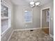 Dining room featuring neutral paint, modern light fixture, and plenty of natural light at 325 Oregon St, Charlotte, NC 28208