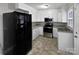 Well-maintained kitchen featuring white cabinets, stainless steel appliances, and durable vinyl flooring at 325 Oregon St, Charlotte, NC 28208