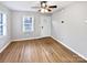 Bright living room with hardwood floors, a ceiling fan, and ample natural light from a window at 325 Oregon St, Charlotte, NC 28208