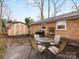 Outdoor patio area with table, chairs, grill, and shed surrounded by a brick wall at 3350 Bonneville Dr, Charlotte, NC 28205
