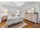 Cozy bedroom with hardwood floors, dresser and a large window for natural light at 3350 Bonneville Dr, Charlotte, NC 28205