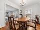 Bright dining room with traditional chandelier over a wood table and hardwood floors at 3350 Bonneville Dr, Charlotte, NC 28205