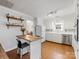 Bright kitchen with white cabinets, island seating, and stainless steel dishwasher with hardwood floors at 3350 Bonneville Dr, Charlotte, NC 28205