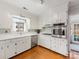 Bright kitchen with stainless steel appliances, white cabinets, and a window overlooking the backyard at 3350 Bonneville Dr, Charlotte, NC 28205