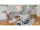Bright living room features hardwood floors, built-in shelves and a large window with a gray couch at 3350 Bonneville Dr, Charlotte, NC 28205