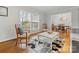 Cozy living room featuring hardwood floors and a view into the adjacent dining area at 3350 Bonneville Dr, Charlotte, NC 28205