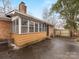 Brick home featuring a screened-in porch, chimney, patio and black front door at 3350 Bonneville Dr, Charlotte, NC 28205