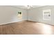 Bedroom with vinyl floors, neutral walls, two windows letting in natural light, and a ceiling fan at 3410 Saddlebred Dr, Gastonia, NC 28052