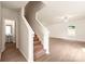Hallway with staircase and vinyl flooring, with a view of the powder room, and the living room at 3410 Saddlebred Dr, Gastonia, NC 28052