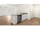 Kitchen island with a stainless steel dishwasher, granite countertops, white cabinets and a faucet at 3410 Saddlebred Dr, Gastonia, NC 28052