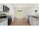 Bright kitchen features modern appliances, granite countertops, white cabinets, and wood-look flooring at 3410 Saddlebred Dr, Gastonia, NC 28052