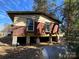 Exterior shot of the home, elevated on supports, with a rustic and aged exterior at 349 N Kendall N St, Norwood, NC 28128