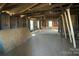 Unfinished interior space featuring exposed beams and natural light through multiple windows at 349 N Kendall N St, Norwood, NC 28128