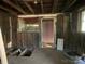 Interior view showing exposed framing and doorway showcasing the home's potential for renovation at 349 N Kendall N St, Norwood, NC 28128