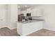 Modern kitchen with white cabinetry, granite countertops, stainless steel appliances and luxury vinyl plank flooring at 3540 Clover Valley Dr, Gastonia, NC 28052