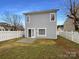 The backyard features a small patio, a white picket fence, and grass at 3937 Northerly Island Ct, Gastonia, NC 28056