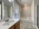 Bright bathroom featuring a shower, garden tub, and a wooden vanity sink at 3937 Northerly Island Ct, Gastonia, NC 28056