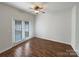 Bright bedroom with hardwood floors, ceiling fan, and patio doors that offer access to outdoor space at 3937 Northerly Island Ct, Gastonia, NC 28056