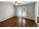 Bright bedroom with hardwood floors, ceiling fan, and patio doors that offer access to outdoor space at 3937 Northerly Island Ct, Gastonia, NC 28056