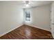 Cozy bedroom features hardwood floors, a ceiling fan, and a window that provides natural light at 3937 Northerly Island Ct, Gastonia, NC 28056
