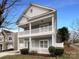 Charming two-story home featuring double porches, white railings, and a well-maintained front yard at 3937 Northerly Island Ct, Gastonia, NC 28056
