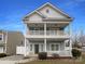 Charming two-story home featuring double porches, white railings, and a well-maintained front yard at 3937 Northerly Island Ct, Gastonia, NC 28056