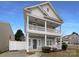 Charming two-story home featuring double porches, white railings, and a well-maintained front yard at 3937 Northerly Island Ct, Gastonia, NC 28056