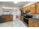 The kitchen features wood cabinets, stainless steel appliances, and marble floors at 3937 Northerly Island Ct, Gastonia, NC 28056