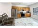 Well-equipped kitchen featuring stainless steel appliances, oak cabinets, and unique marble-look flooring at 3937 Northerly Island Ct, Gastonia, NC 28056
