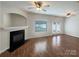 Inviting living room with hardwood floors, fireplace, ceiling fans, and natural light from windows and glass doors at 3937 Northerly Island Ct, Gastonia, NC 28056