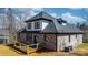 New home's backyard featuring a wooden deck, gray brick exterior, and ample space for outdoor activities at 4060 Steve Ikerd Ne Dr, Hickory, NC 28601