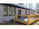 Comfortable backyard setting with a wooden deck and brick walls, creating a private and relaxing outdoor area at 4060 Steve Ikerd Ne Dr, Hickory, NC 28601
